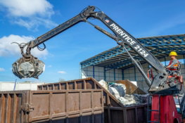crane-with-grapple-loading-debris-into-a-dumpster.jpg Crane with grapple loading debris into a dumpster