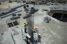a-group-of-men-standing-on-top-of-a-construction-site.jpg a group of men standing on top of a construction site